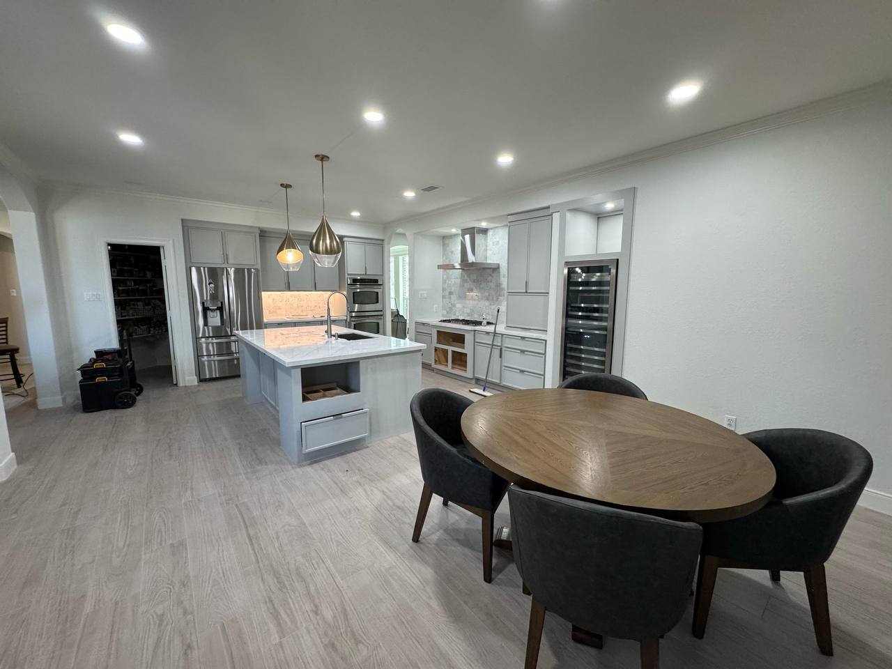 Completed modern gray kitchen with island and stainless appliances